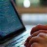 Typing on a laptop, representing press release writing